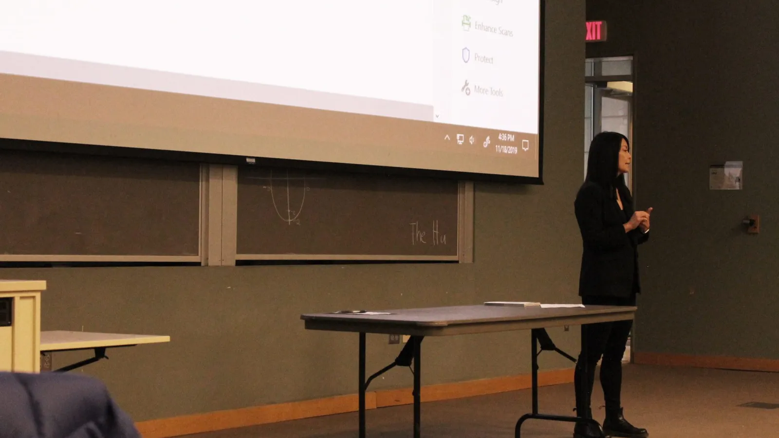Woman in front of a projection screen
