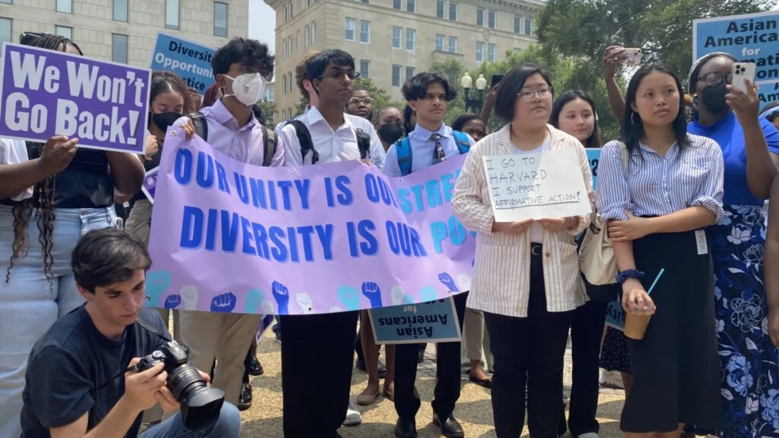 A group of students holding a banner