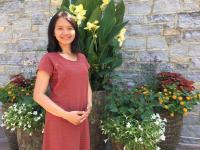 Maretha Dellarosa standing in front of flower pots