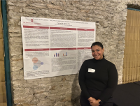 woman standing in front of a large poster