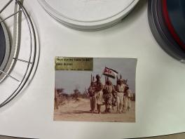 A rectangle with people shown inside of it next to three film reels.