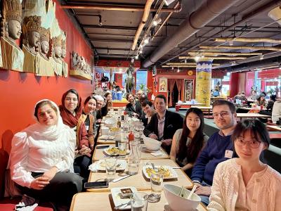 Clarissa Ma and colleagues at a big table in a restaurant