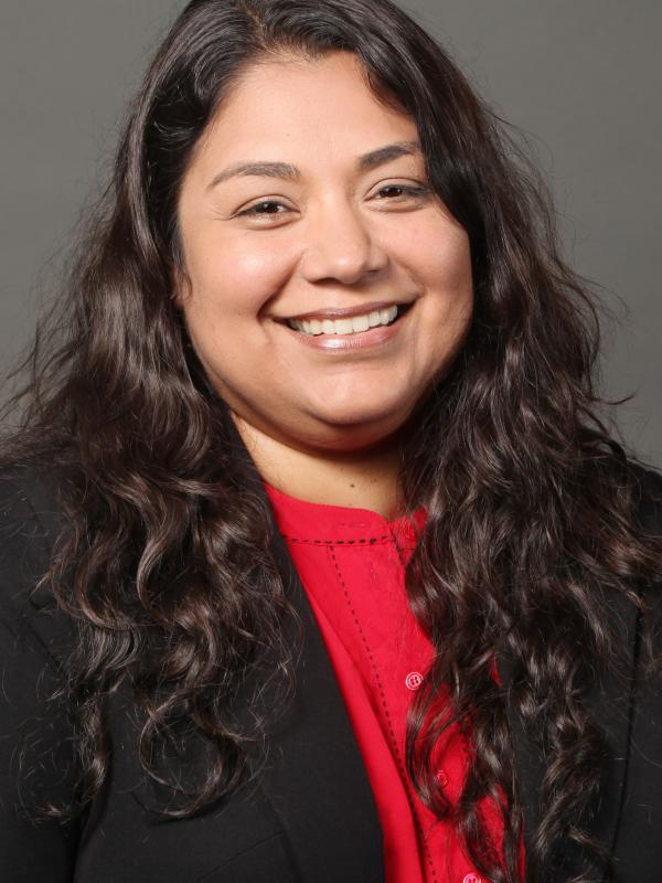 Nancy Mendoza in a red shirt with a black sweater