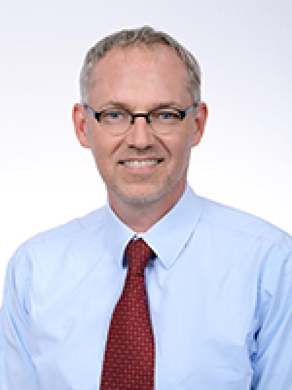 Peter Sayer in a blue shirt with a red tie