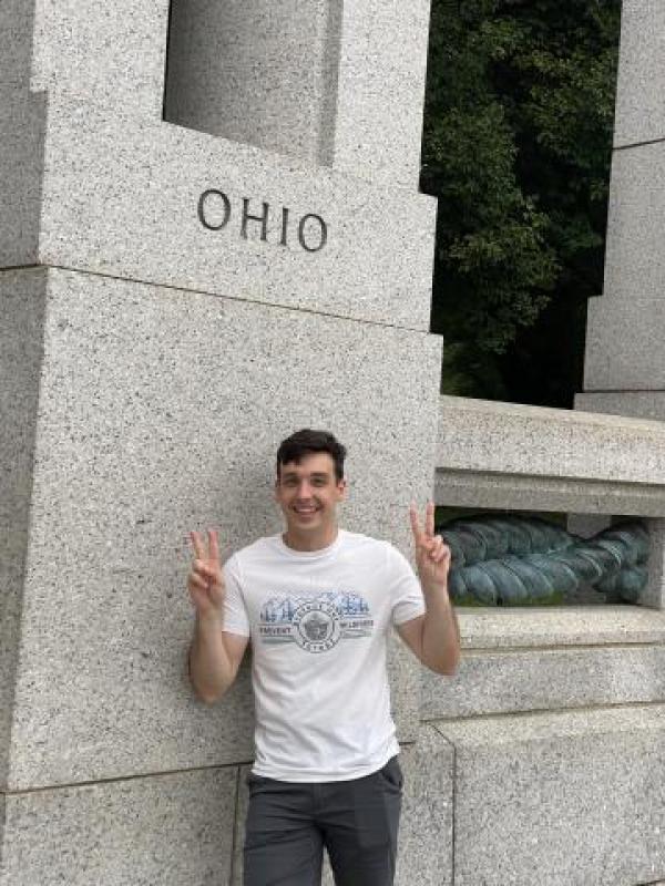 Connor stands at a building where "Ohio" is carved into the wall. 